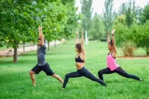 young-people-exercising-yoga-in-a-park-JSMF00530